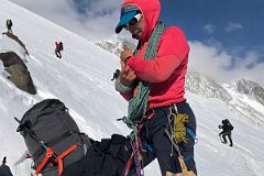 05A Climbers Continue Climbing While Guide Pachi Ibarra Rests In The Rock Band On The Climb Up The Fixed Ropes To High Camp.jpg